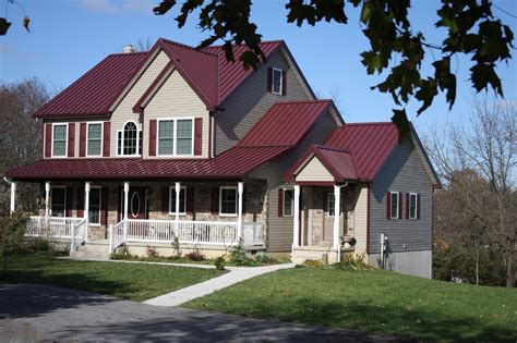 red house with brown metal roof|homes with red metal roofs.